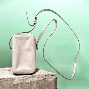 Kate Spade New York Kitt North South Phone Crossbody bag in a tan nylon fabric.